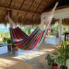 Multicolor Hammock_Handwoven embroidery and loom_Hamaca tipica de Guatemala_under palm roof bright