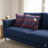 Coussin huipil birds sur sofa bleu - motif oiseau large mauves